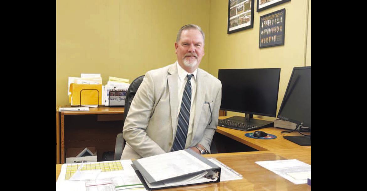 NEW KINGFISHER Interim Superintendent Sean McDaniel sits at his new desk shortly after being named to the position during a special meeting of the board of education on Thursday. [KT&amp;FP Staff Photo]