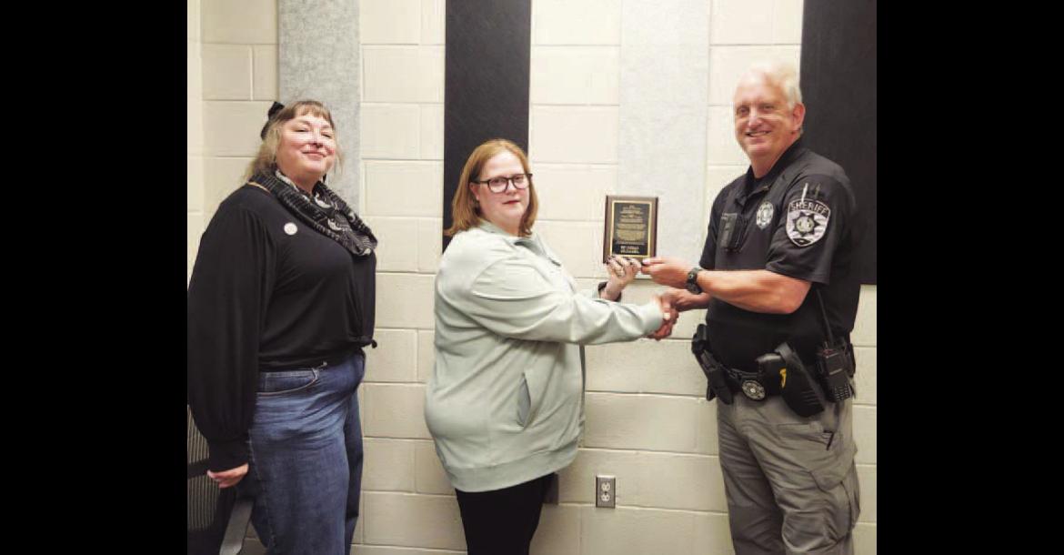 HARD WORK RECOGNIZED – Amanda Newland-Hale, center, and Jennifer Eastwood, left, co-founders and co-directors of the nonprofit organization Oklahoma Cold Cases, Inc., presented KCSO Lt. Mike Shults, right, with its 2026 Distinguished Partnership Award on Thursday during a ceremony at the sheriff’s office. Shults was recognized for his continued work on the cold case of the murder of Mary Harrison, which took place nearly 50 years ago. [KT&amp;FP Staff Photo]