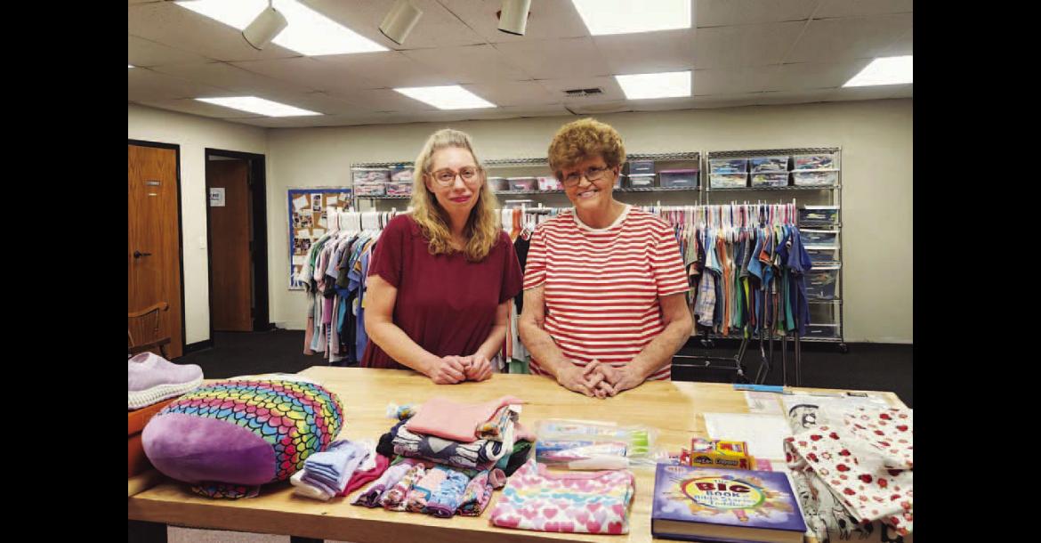 CARE CLOSET – Sharon Miller (left) and Ronda Shepherd are pictured in a space at Kingfisher First Baptist Church that serves as the storage for Care Closet, which provides clothing and other materials to the underprivileged. Pictured on the right is an example of some of the items Miller and Shepherd make available for youth who might be in need. [KT&amp;FP Staff Photos]