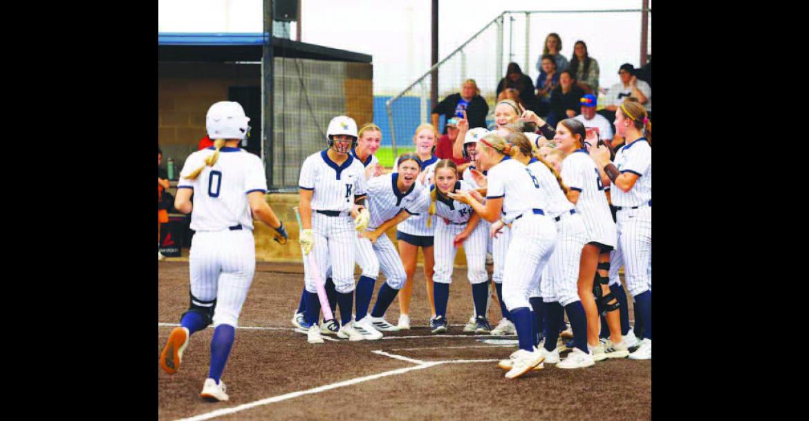 KINGFISHER SOFTBALL players await the arrival of Lily Voth (0) at home plate after she hit her second home run of the team’s 10-4 win against Cushing at home on Thursday in a Class 4A regional tournament game. The Lady Jackets followed that up with a 12-1 run rule win over Ada to put them just one win away from the program’s first ever regional title. See inside for more. [KT&FP Staff Photo]