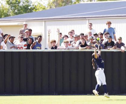 LILIANA GARRAMONE makes a leaping catch in left field in front of a group of Broken Bow students during Kingfisher’s 7-2 victory on Wednesday in the opener of a Class 4A softball super regional. [KT&amp;FP Staff Photo]