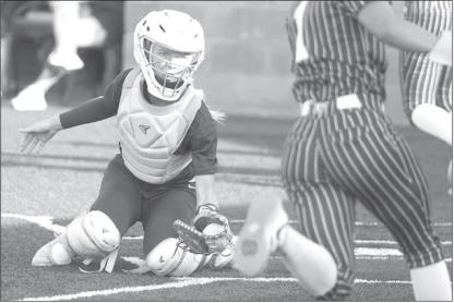 SENIOR CATCHER Adlee Friesen waits to make a tag at home plate after a throw from centerfield by Kendall Farrar on Monday. Farrar and Friesen connected for two such outs at home plate, but Enid still managed a 6-0 win. [KT&amp;FP Staff Photo]