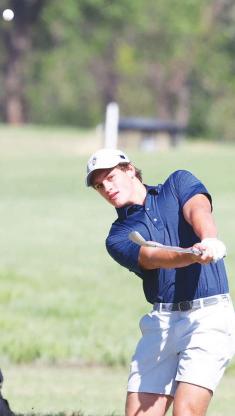 CALE REAGAN watches a chip shot during a golf tournament earlier this year. Reagan helped lead KHS to the state golf tournament and won an all-star tournament after the season. He’s pictured on the right side of the page during his junior year of football. A dominant defensive lineman for the Jackets, he was named the 3A-1 Defensive Player of the Year as a senior. [Golf photo by KT&FP Staff/Football photo by Chris Simon